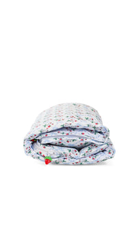 Folded floral-patterned nap mat on a white background
