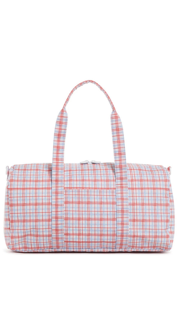 Plaid patterned duffel bag on a white background
