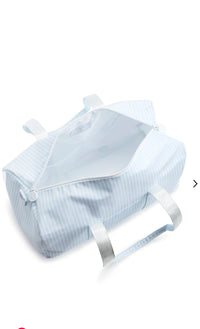 A blue stripe duffel bag with handles and a zipper opened