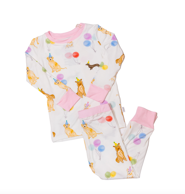 Children's pajama set with dog and balloon pattern on a white background
