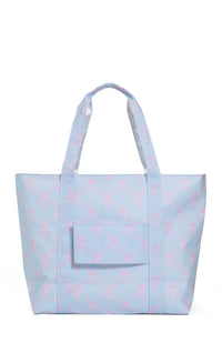 Light blue tote bag with pink bow pattern on a white background
