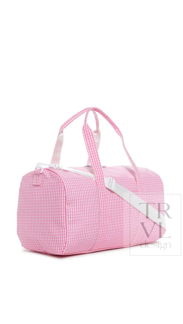 Pink gingham TRVL Weekender duffel bag side view with detachable strap