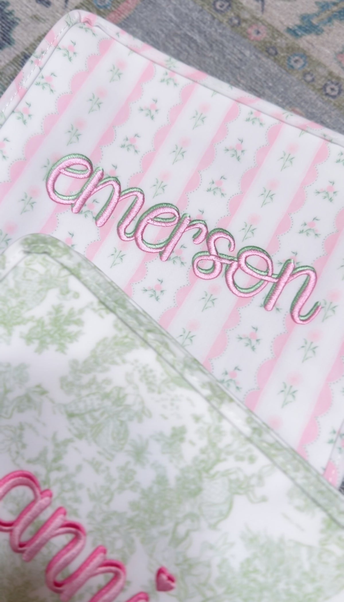 Pink ribbon floral roadie embroidered with the name Emerson