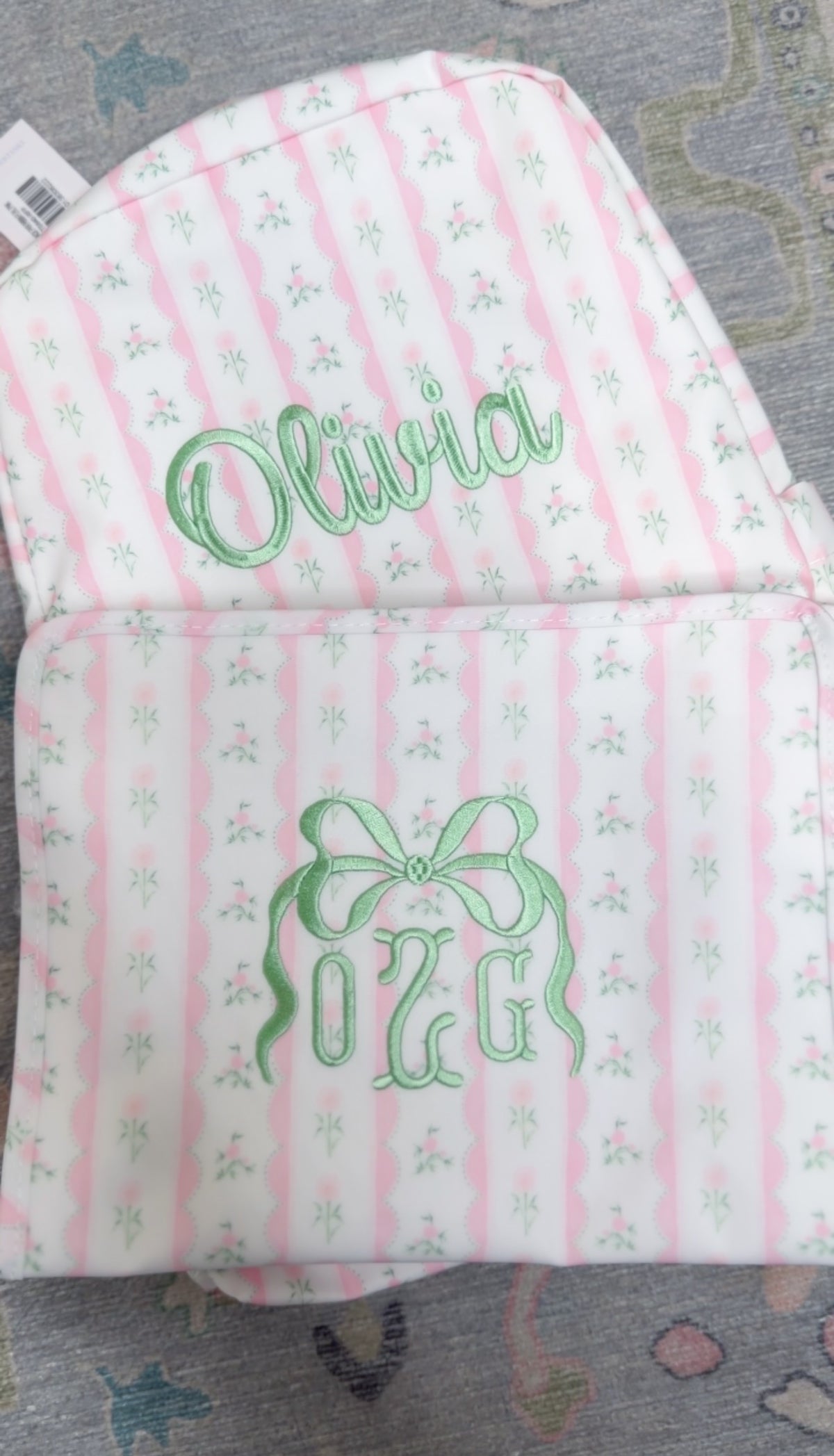 Pink ribbon floral roadie backpack embroidered with the name Olivia and OZG bow monogram