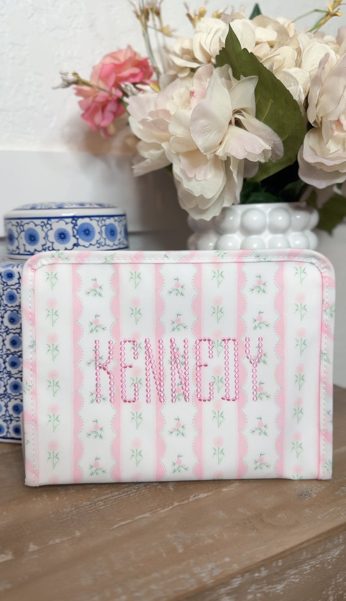 Pink ribbon floral roadie embroidered with the name Kennedy