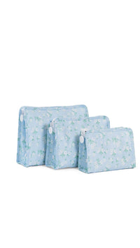 Set of three light blue fabric bags with floral patterns on a white background