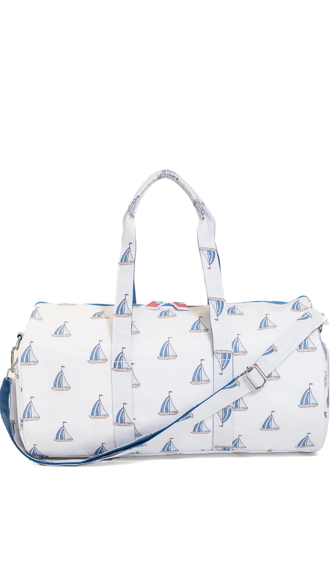 White duffel bag with sailboat pattern on a white background