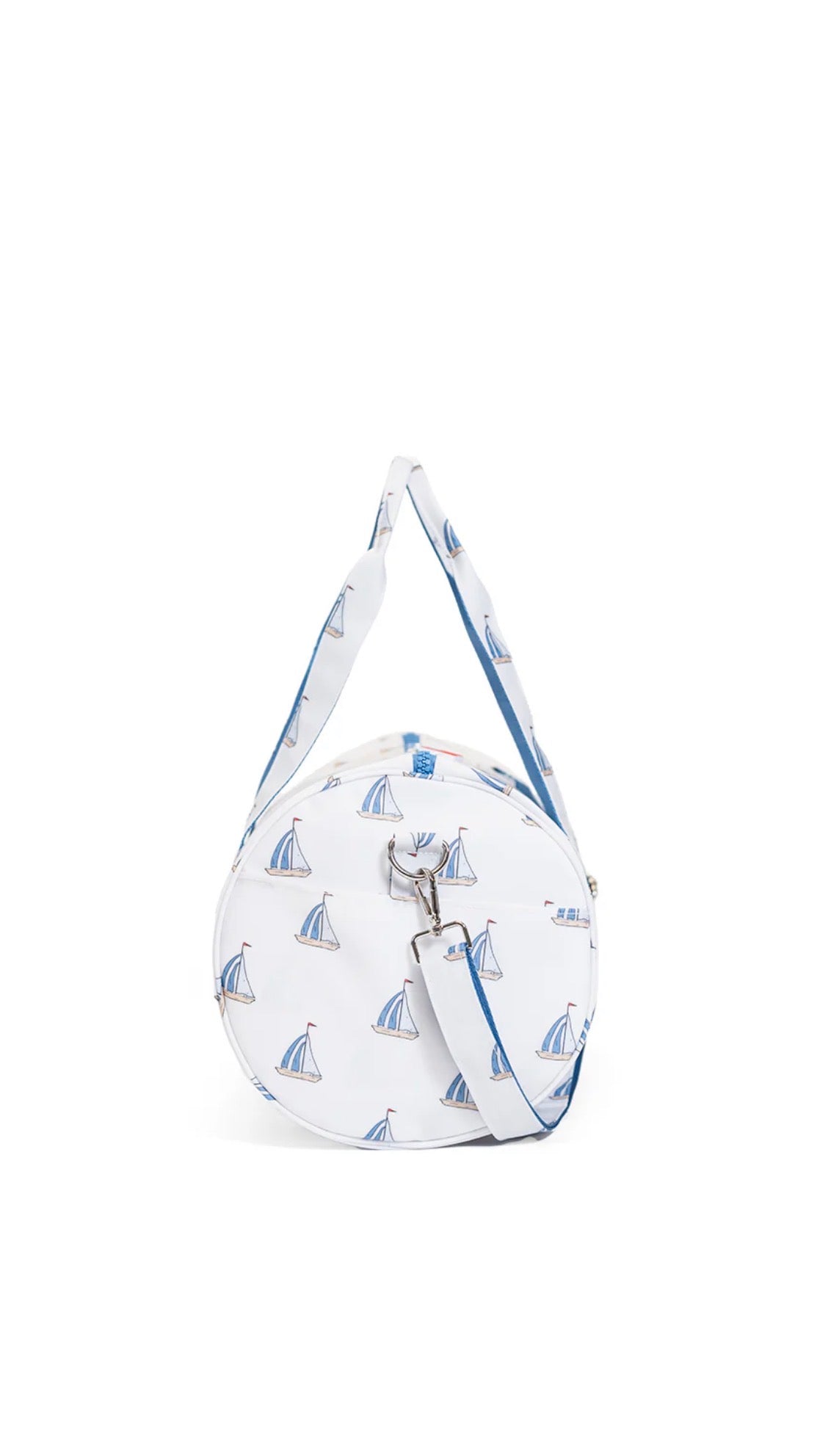 Round bag with sailboat pattern and a strap on a white background