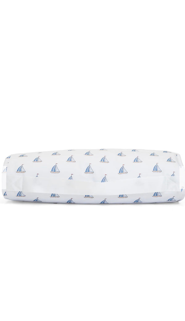 Folded nap mat with sailboat pattern on a white background