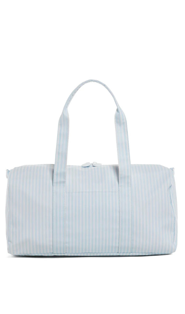 A blue striped duffel bag with handles, depicted against an isolated background.
