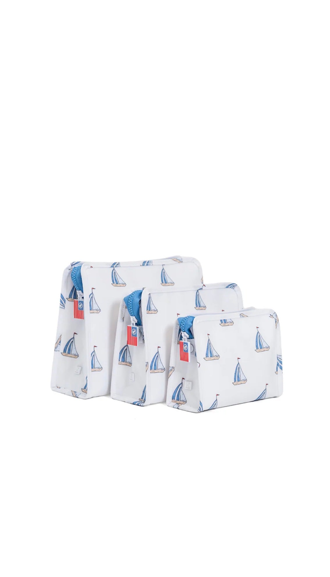 Set of three fabric bags with sailboat pattern on a white background