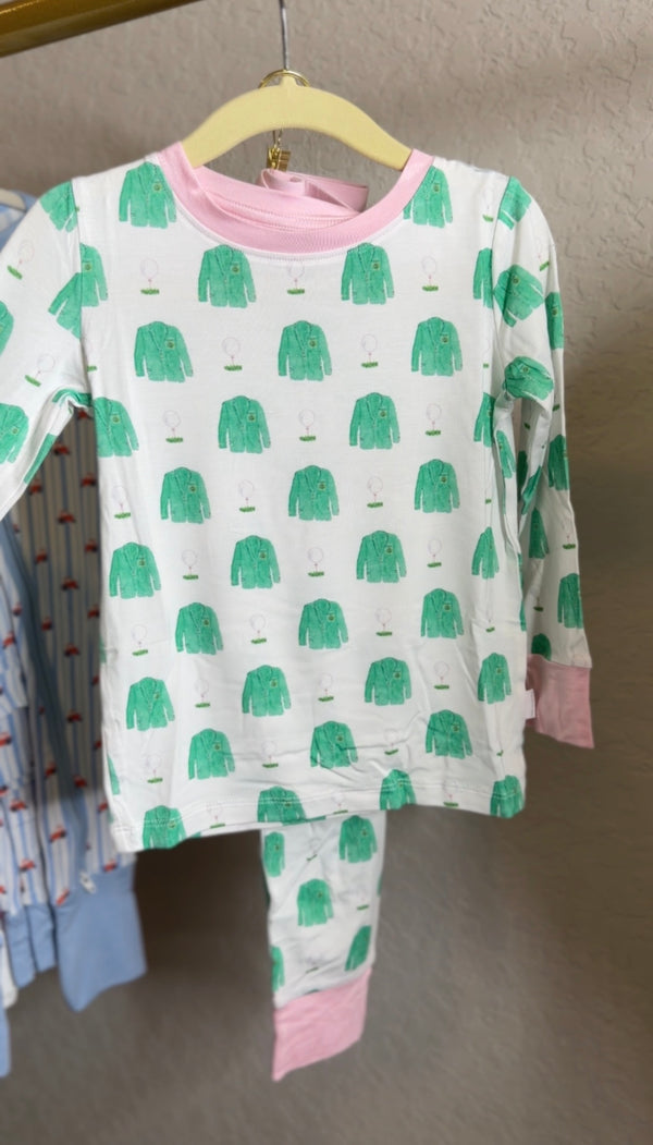 Children's pajama set with green coat pattern on a hanger against a neutral background