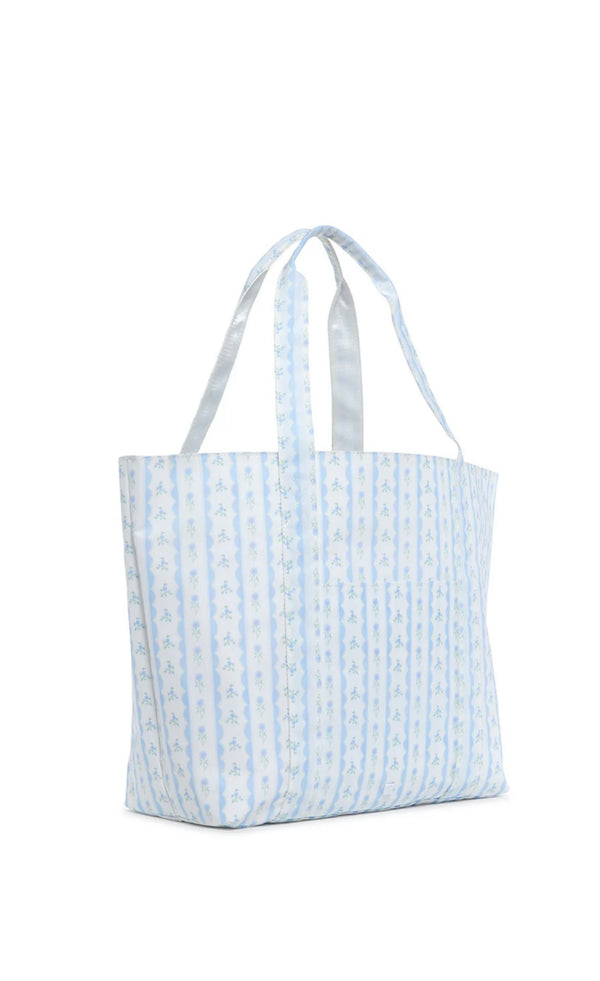 A blue floral tote bag with a structured design and satin webbing handles.
