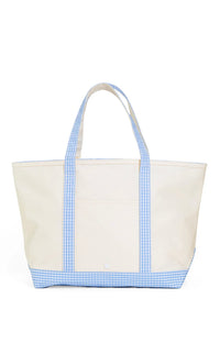 A large canvas tote bag with blue gingham trim on the handles and bottom, with a white background.