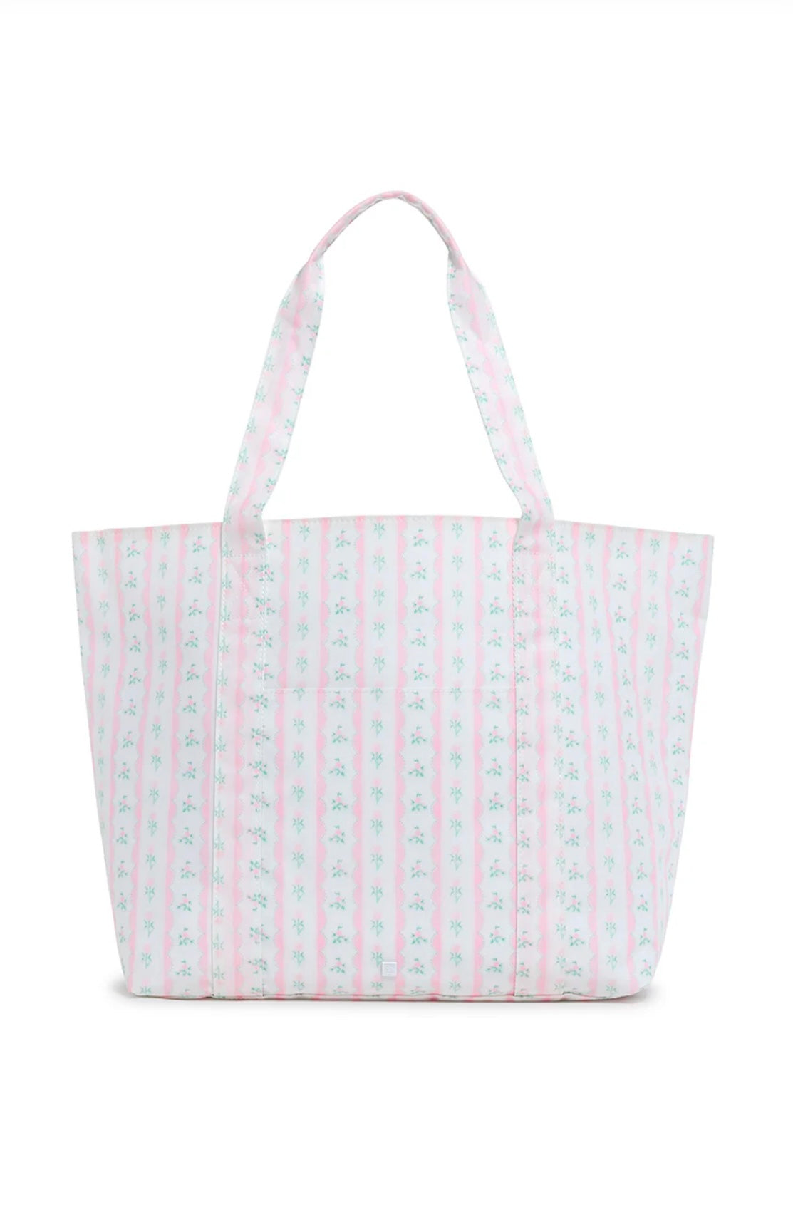 A pink floral jumbo tote bag with two handles, a front exterior pocket, and a striped pattern.