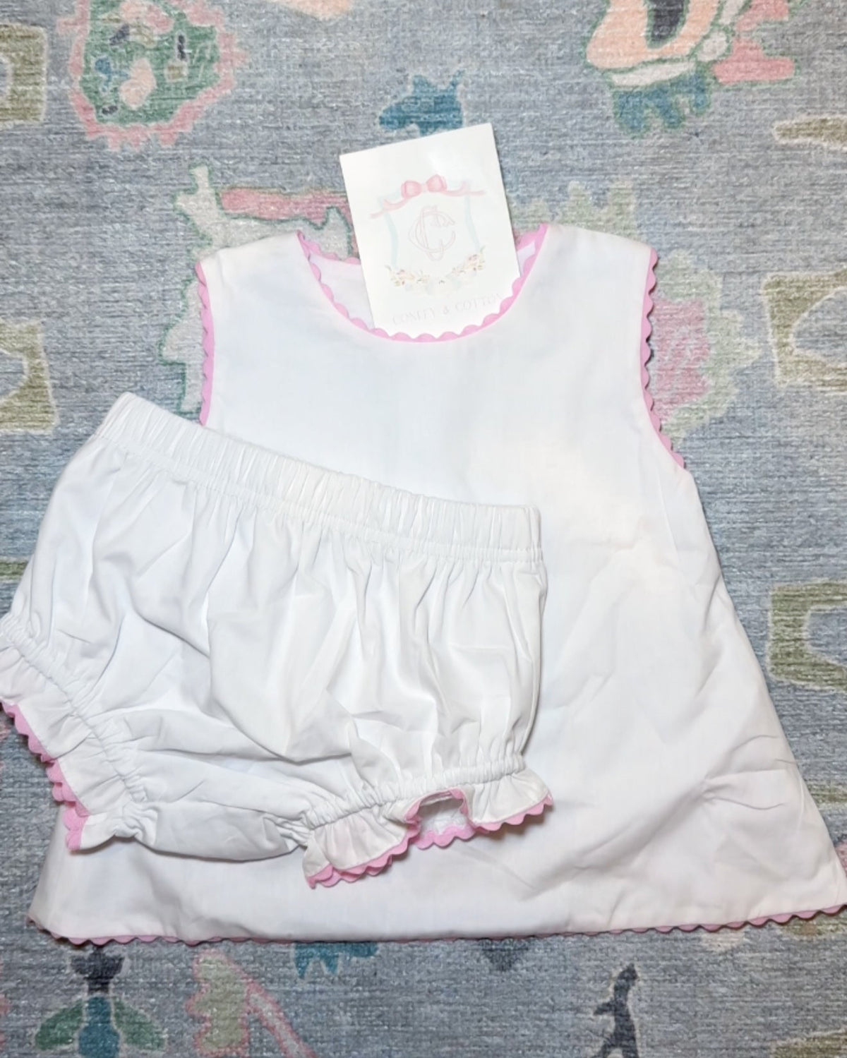 White diaper set with pink ricrac trim