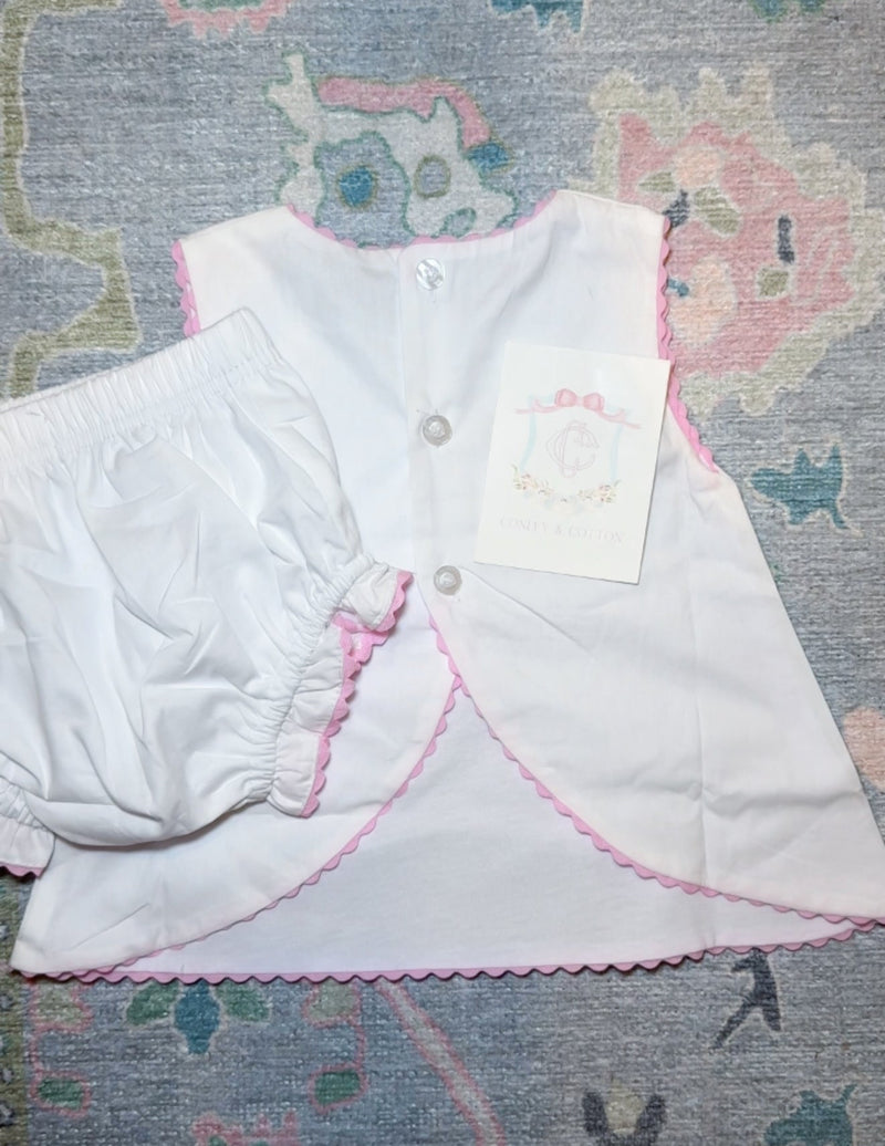 White diaper set with pink ricr ac trim back