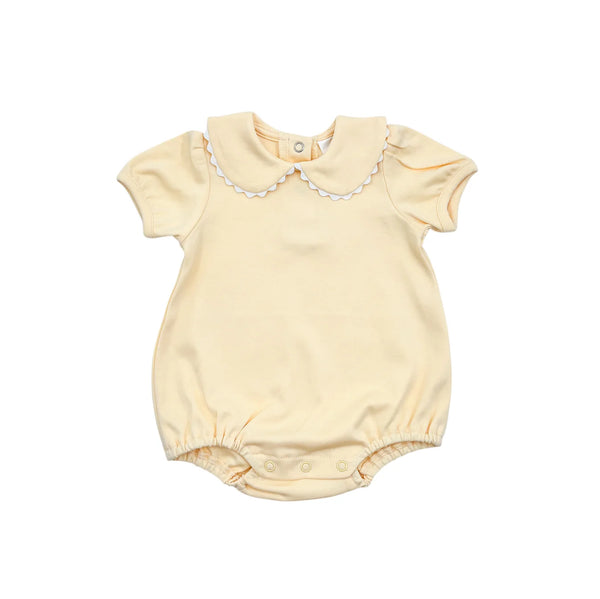 Yellow baby romper with ricrac  collar on a white background