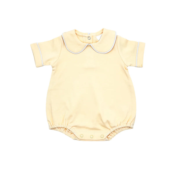 Yellow baby romper with white trim on a white background