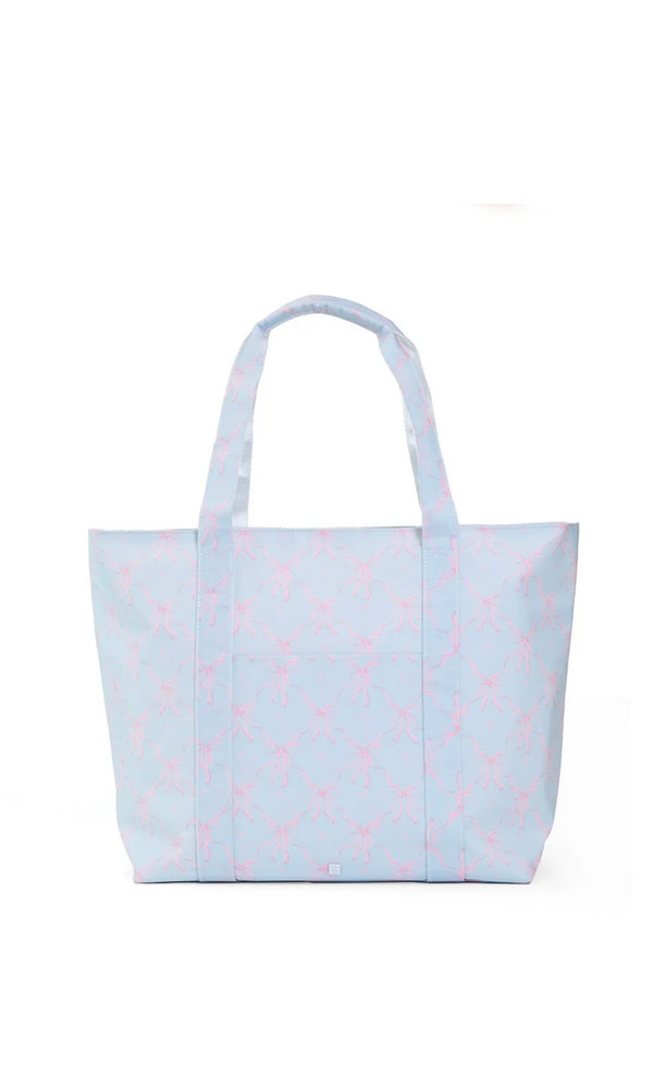 Light blue tote bag with pink bow pattern on a white background