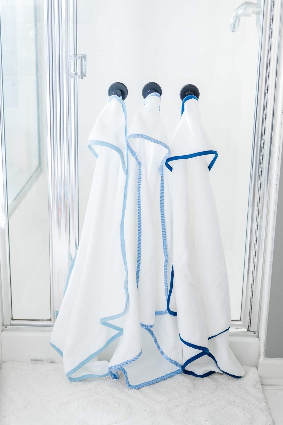 Hooded towel for baby, available in blue and pink gingham