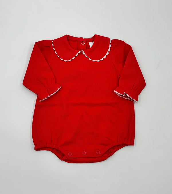 Red baby romper with white trim on a light gray background