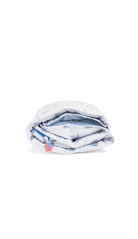 Folded nap mat with sail boat pattern on a white background
