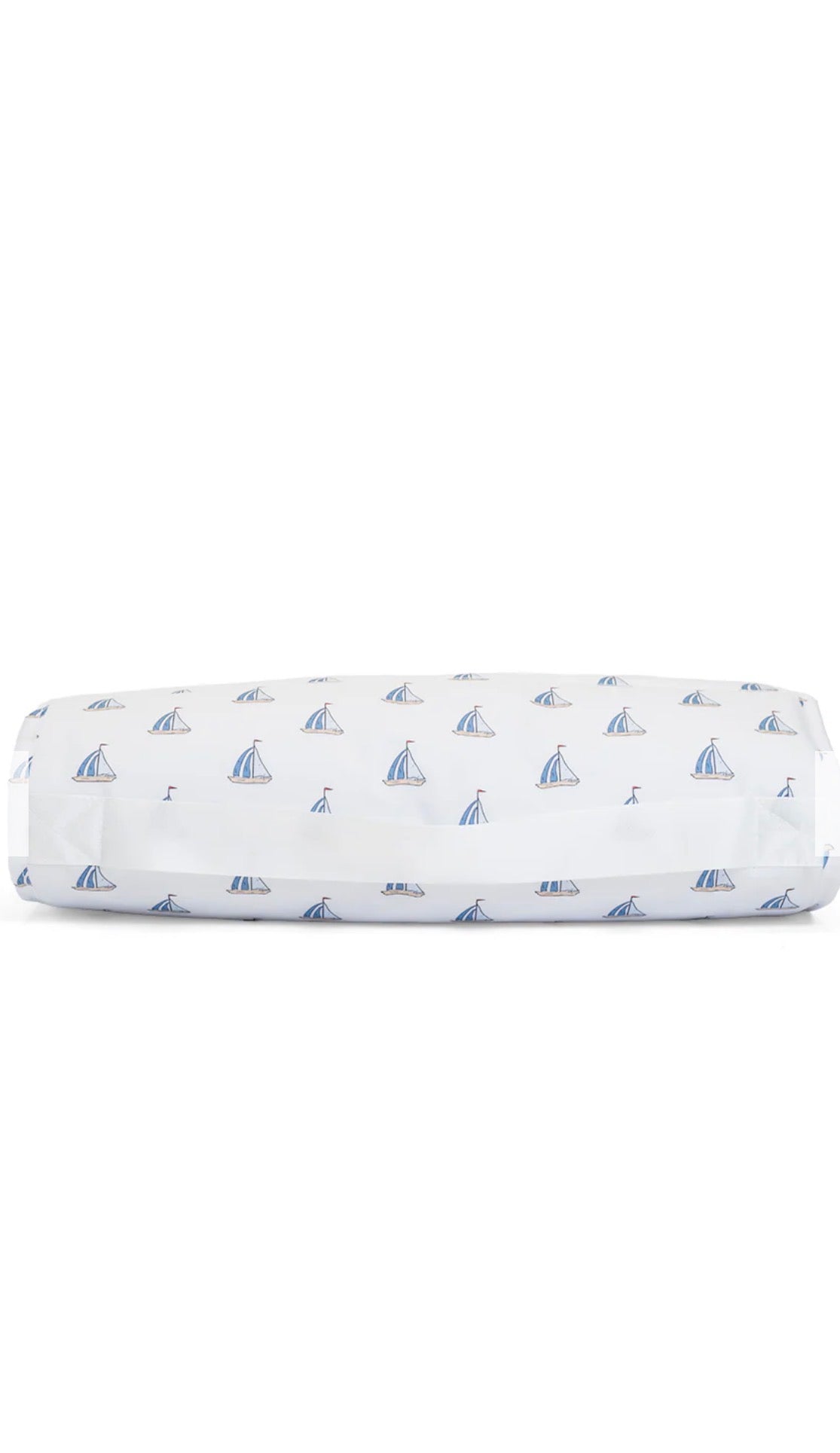 Folded nap mat with sailboat pattern on a white background