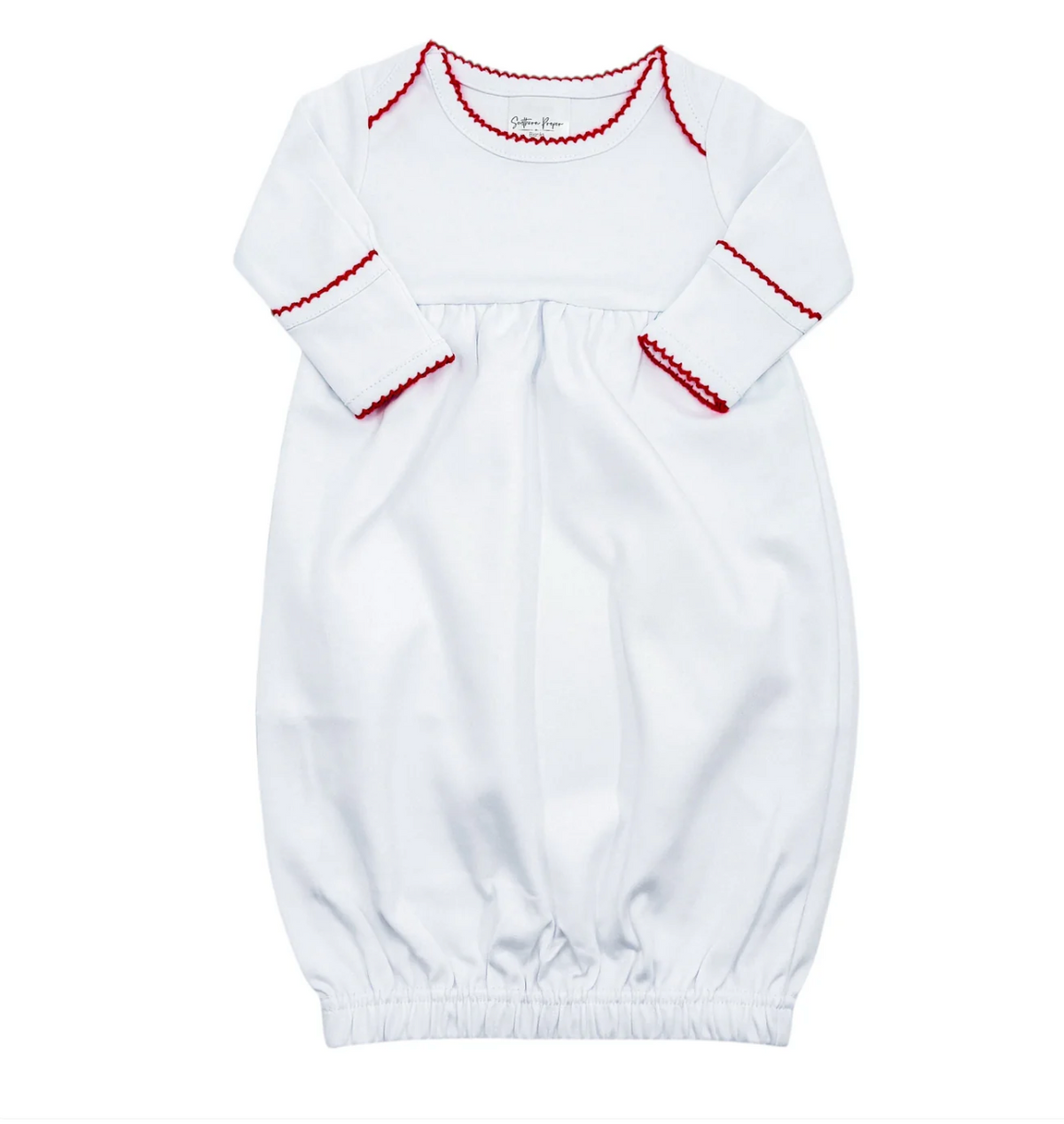 White baby gown with red trim on a white background