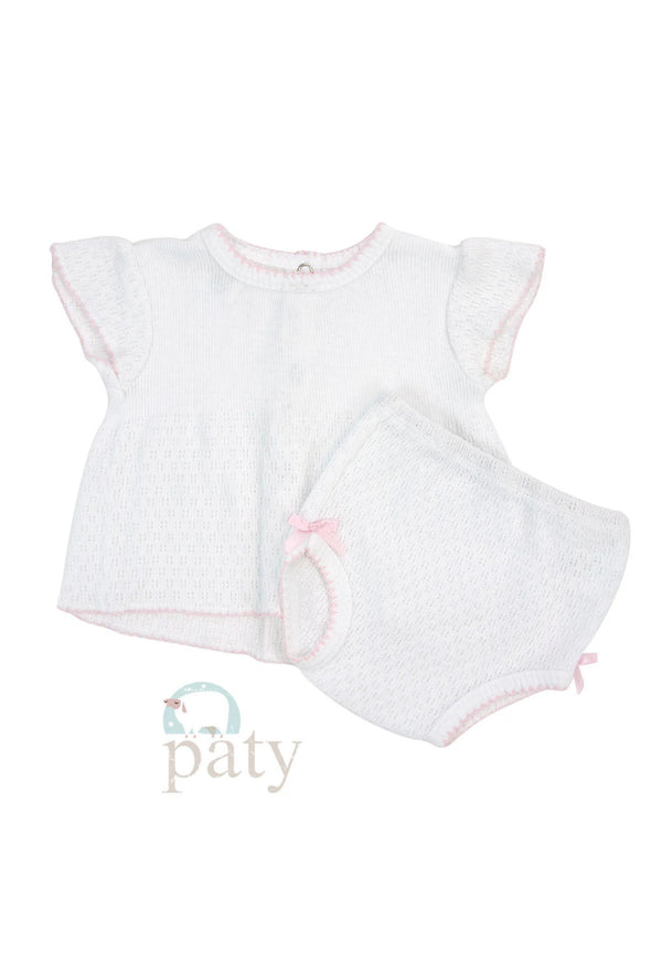 A white baby diaper set with pink trim, including a top with delicate flutter sleeves and matching bloomers with pink scalloped edging and bows at the legs.