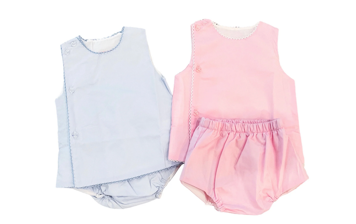 Light blue and pink cotton diaper sets side by side, each with a sleeveless top with scalloped trim and bloomer bottoms