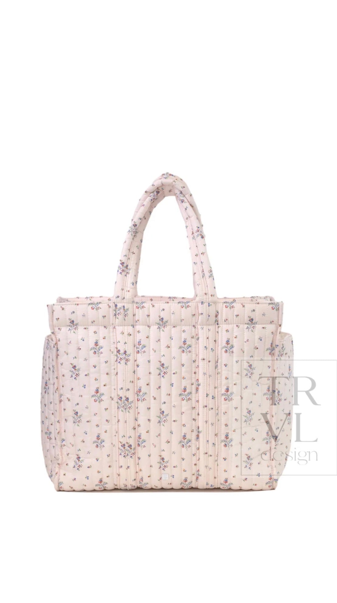 Cream quilted TRVL Go Go Tote with a small pink and blue floral print, front view with double handles