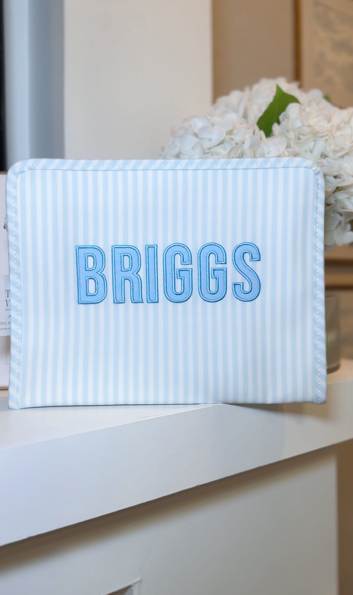 Blue Pimlico stripe TRVL Roadie pouch embroidered with 'BRIGGS' in bold block letters
