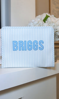 Blue Pimlico stripe TRVL Roadie pouch embroidered with 'BRIGGS' in bold block letters