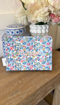 Blue floral TRVL pouch embroidered with the name 'Miriam' in pink script