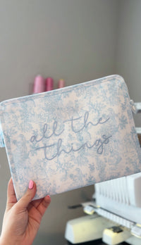 Blue bunny toile TRVL pouch embroidered 'all the things' in blue script