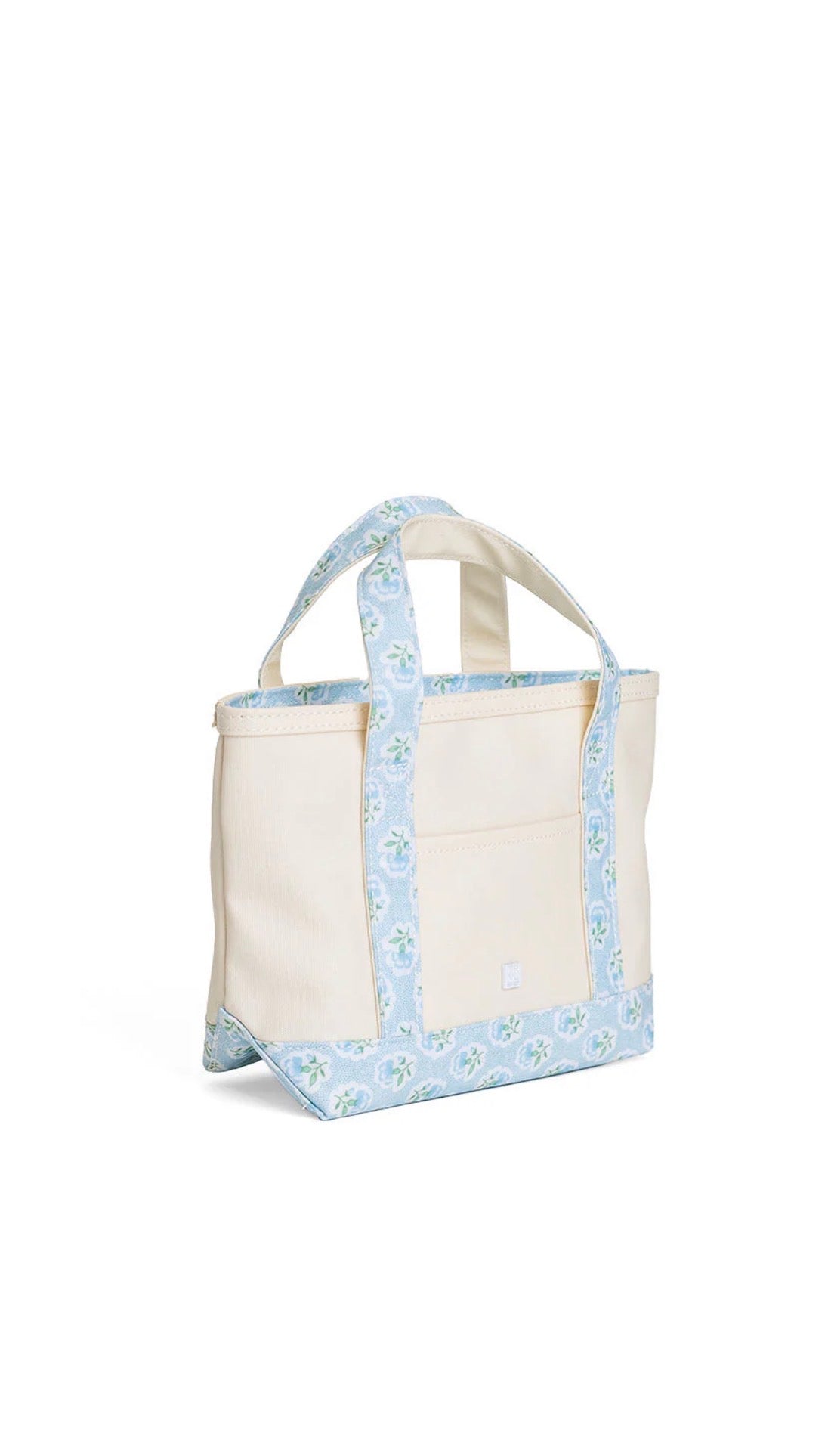 Natural coated canvas TRVL mini tote with blue petite fleur floral trim