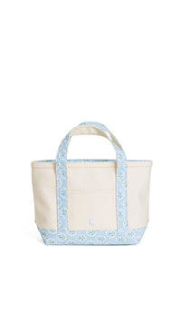 Natural coated canvas TRVL mini tote with blue petite fleur floral trim