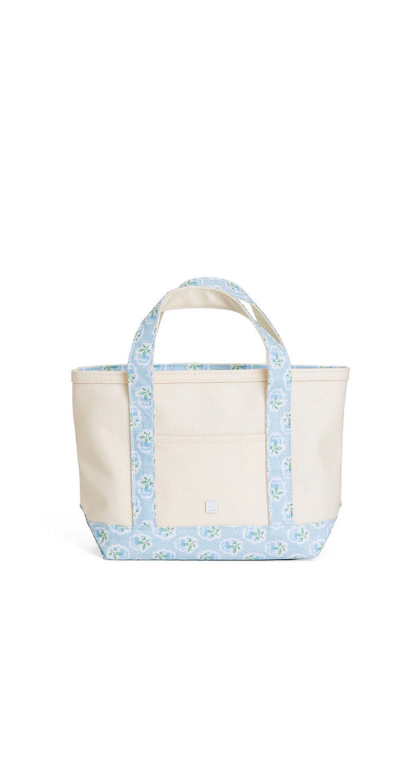 Natural coated canvas TRVL mini tote with blue petite fleur floral trim