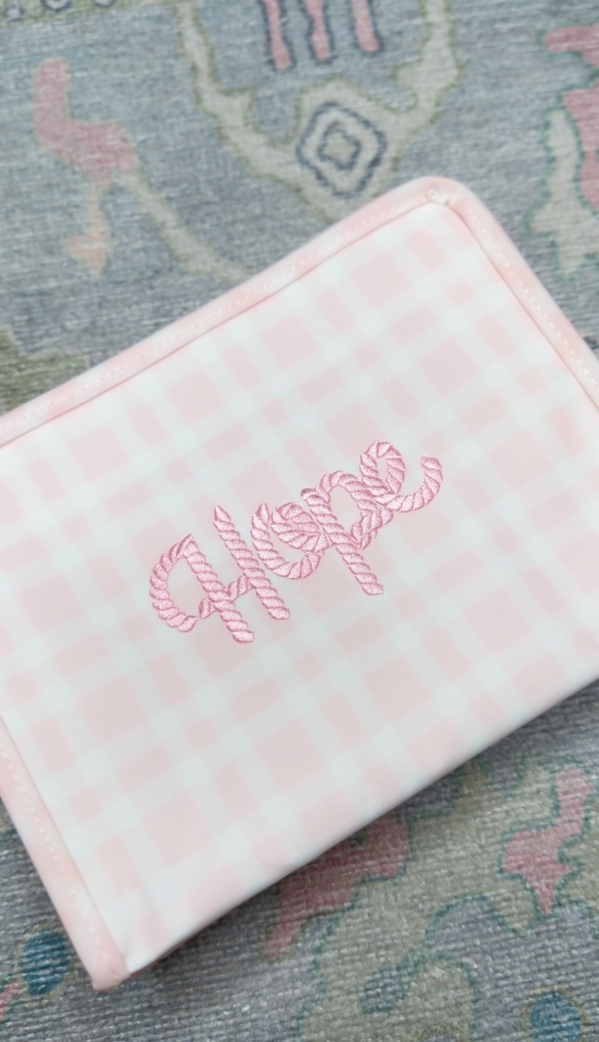 Pink gingham TRVL pouch embroidered 'Hope' in pink candy-cane style script