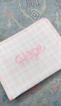 Pink gingham TRVL pouch embroidered 'Hope' in pink candy-cane style script