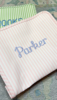 Pink Pimlico stripe TRVL Roadie pouch embroidered with 'Parker' in cursive script