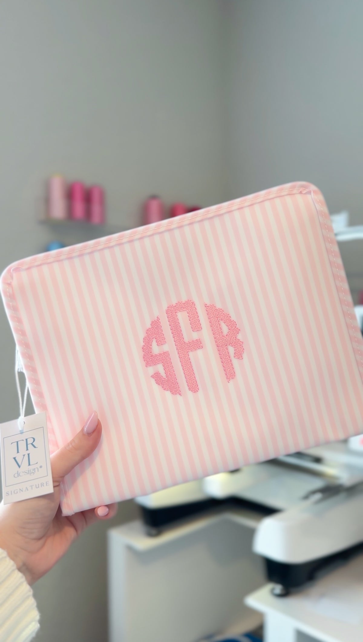 Pink Pimlico stripe TRVL Roadie pouch embroidered with 'SFR' monogram in a circular design