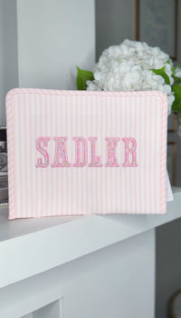 Pink Pimlico stripe TRVL Roadie pouch embroidered with 'SADLER' in outlined block letters