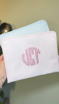Pink Pimlico stripe TRVL Roadie pouch embroidered with 'VCT' monogram in scalloped letters