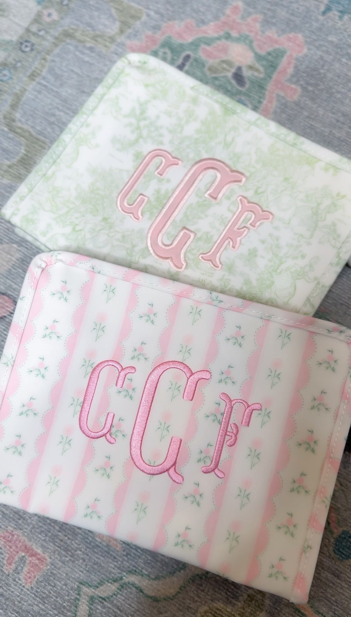 Two personalized pink ribbon floral roadie pouches with monogram embroidery