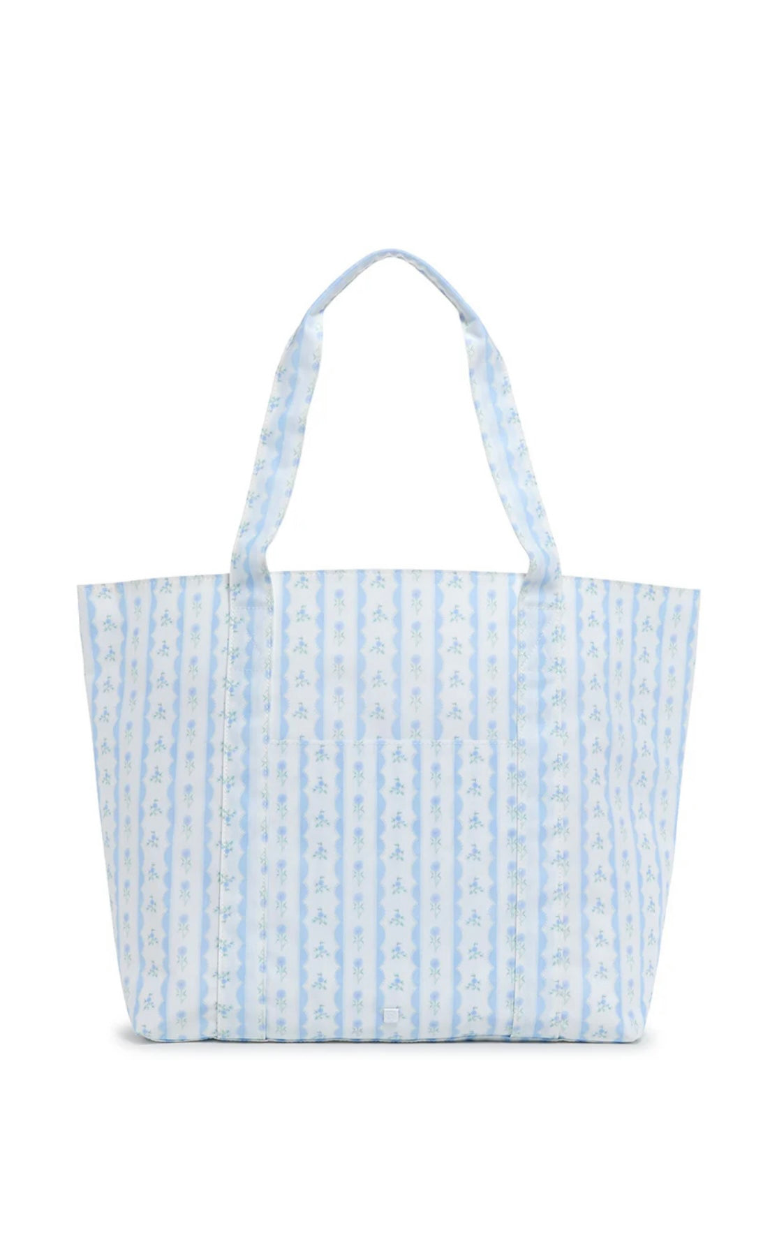 A blue floral tote bag with a structured design and satin webbing handles.