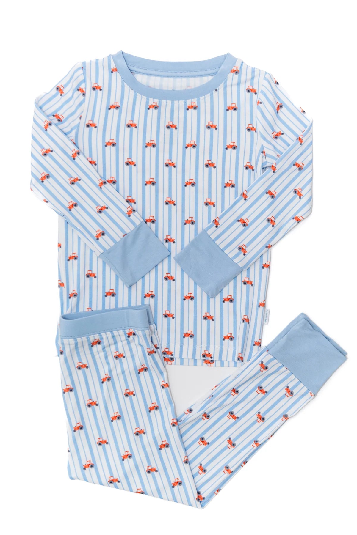 Children's pajama set with red tractors pattern on a white background