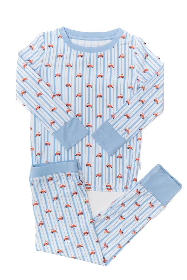 Children's pajama set with red tractors pattern on a white background