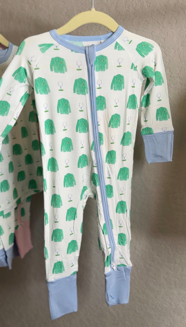 Baby onesie with green coat pattern on a hanger against a neutral background